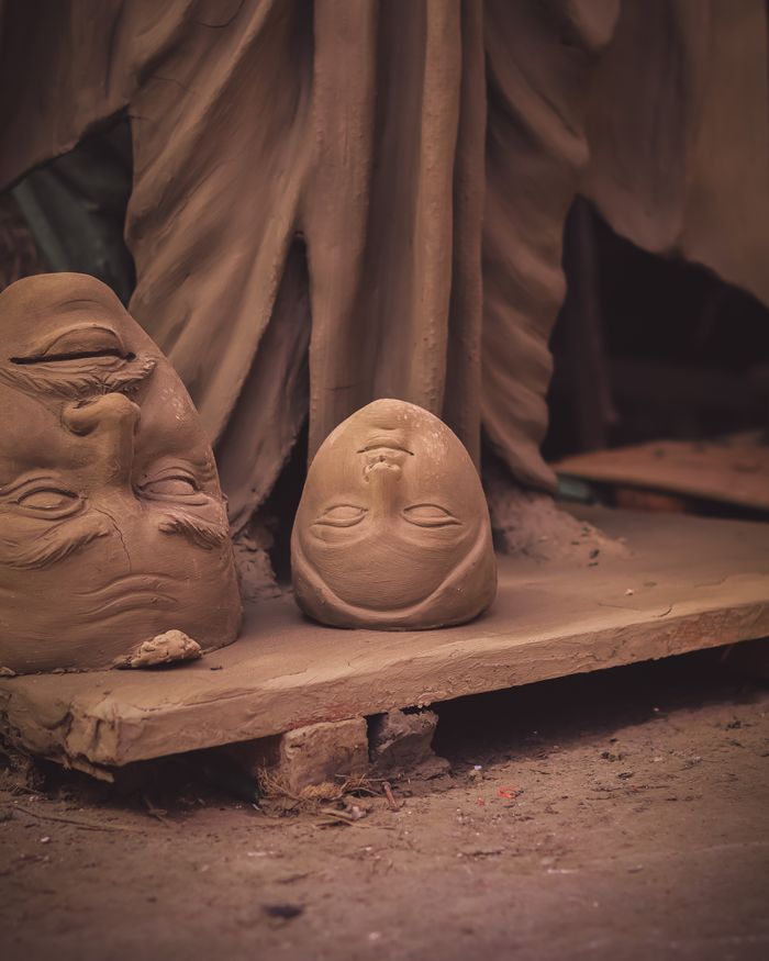 Intricate clay sculptures in a workshop, showcasing artistic craftsmanship.