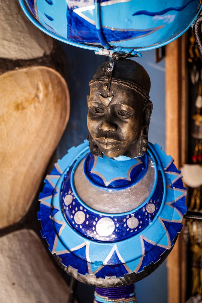 Vibrant African sculpture featuring traditional design and intricate patterns in blue tones.