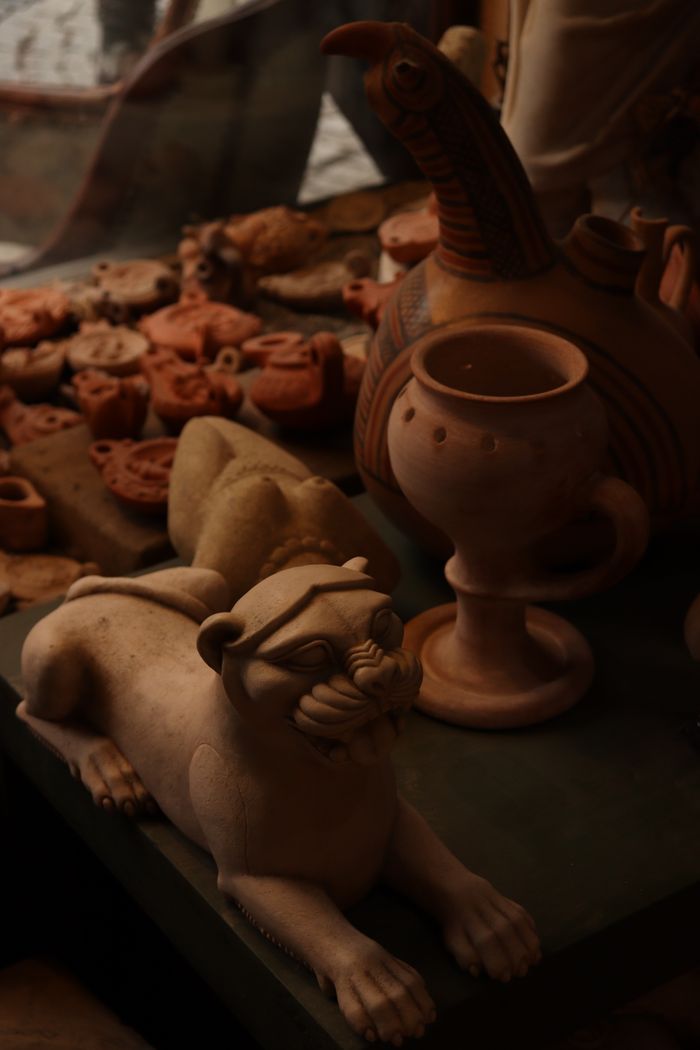 The Art of Drawing Readers In: Your attractive post title goes here A collection of artistic pottery and sculptures displayed in a workshop setting.